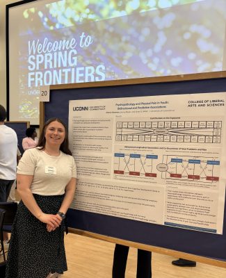 Photo of RA Alexsia presenting her poster on her senior thesis